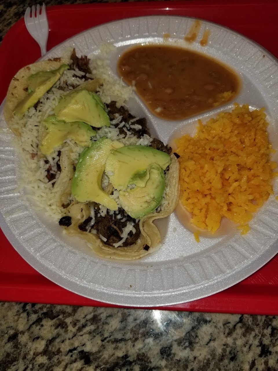 Menu board with tacos, burritos, and quesadillas.